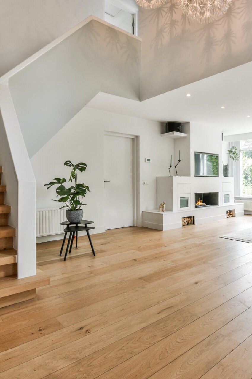 Spacious living room with light-toned hardwood flooring and modern furnishings